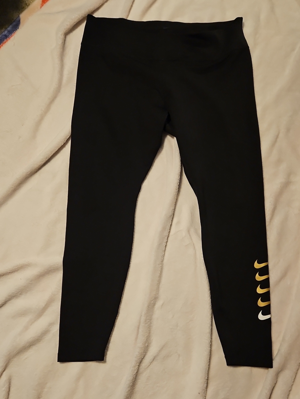 Nike Black Leggings with Gold and White Swoosh Accents